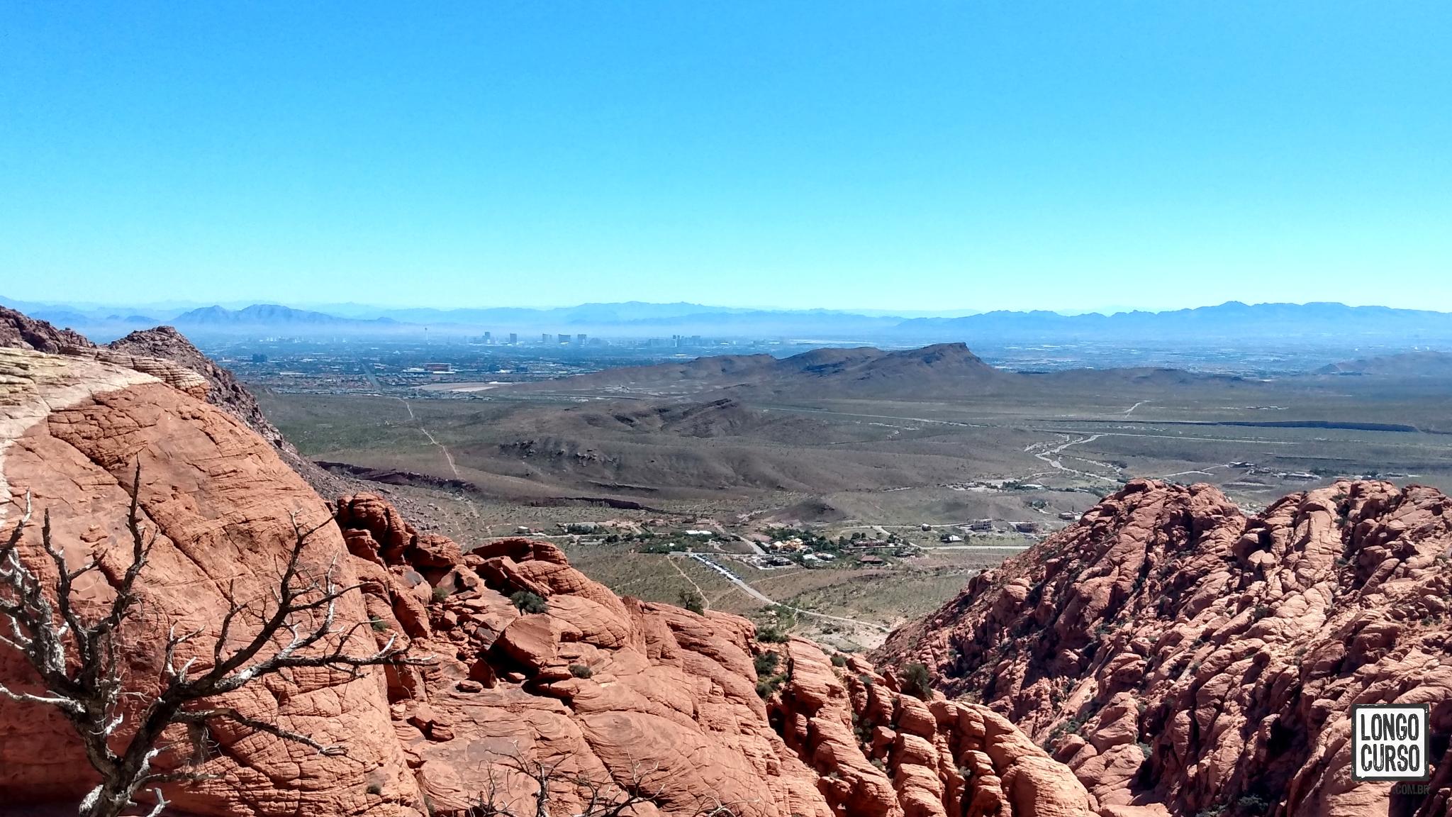 Visual no final da CalicoTanks. No primeiro plano, uma cidade próxima ao Red Rock Canyon. Ao fundo, Las Vegas. É possível identificar a torre do Stratosphere à esquerda.